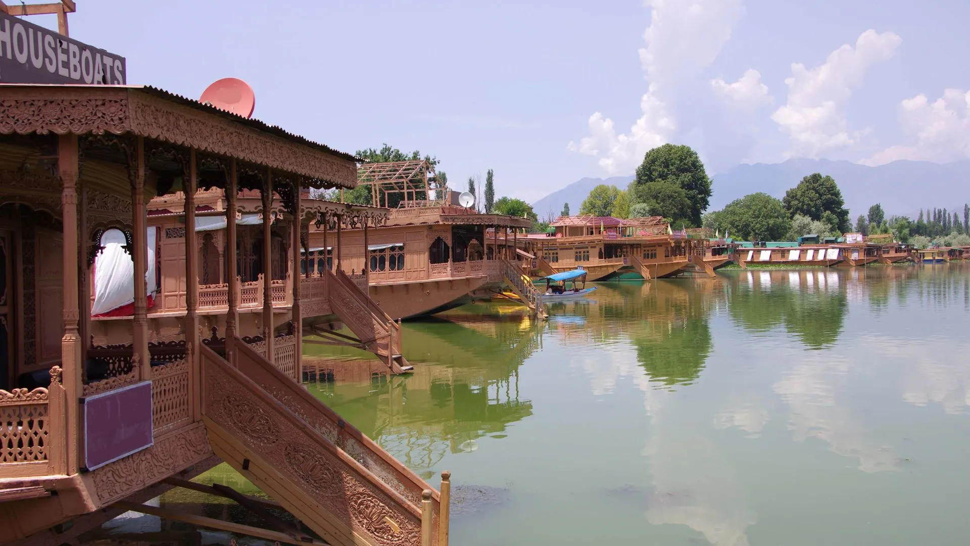 Several Thai house boats on a body of water