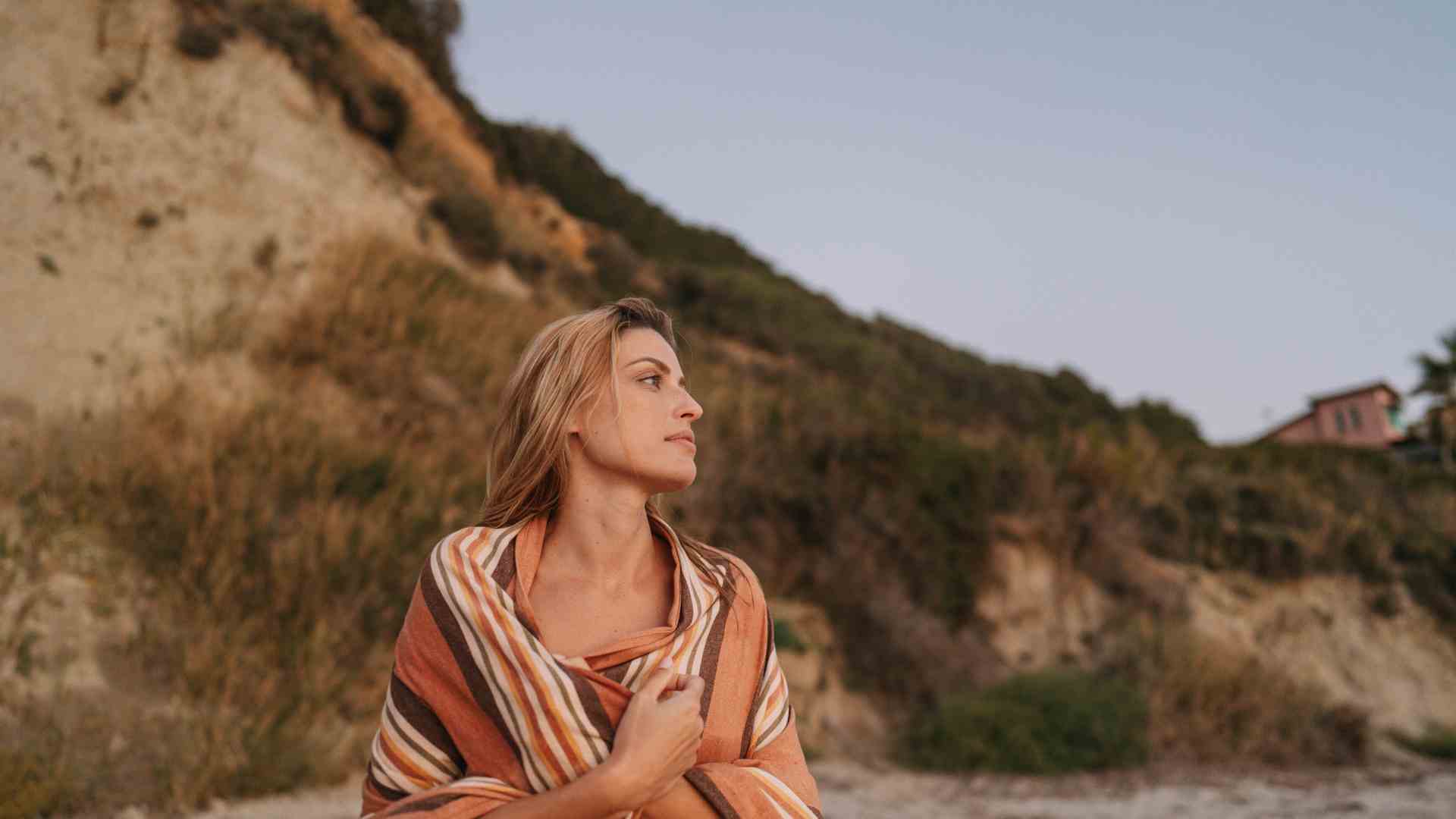 girl being mindful on beach