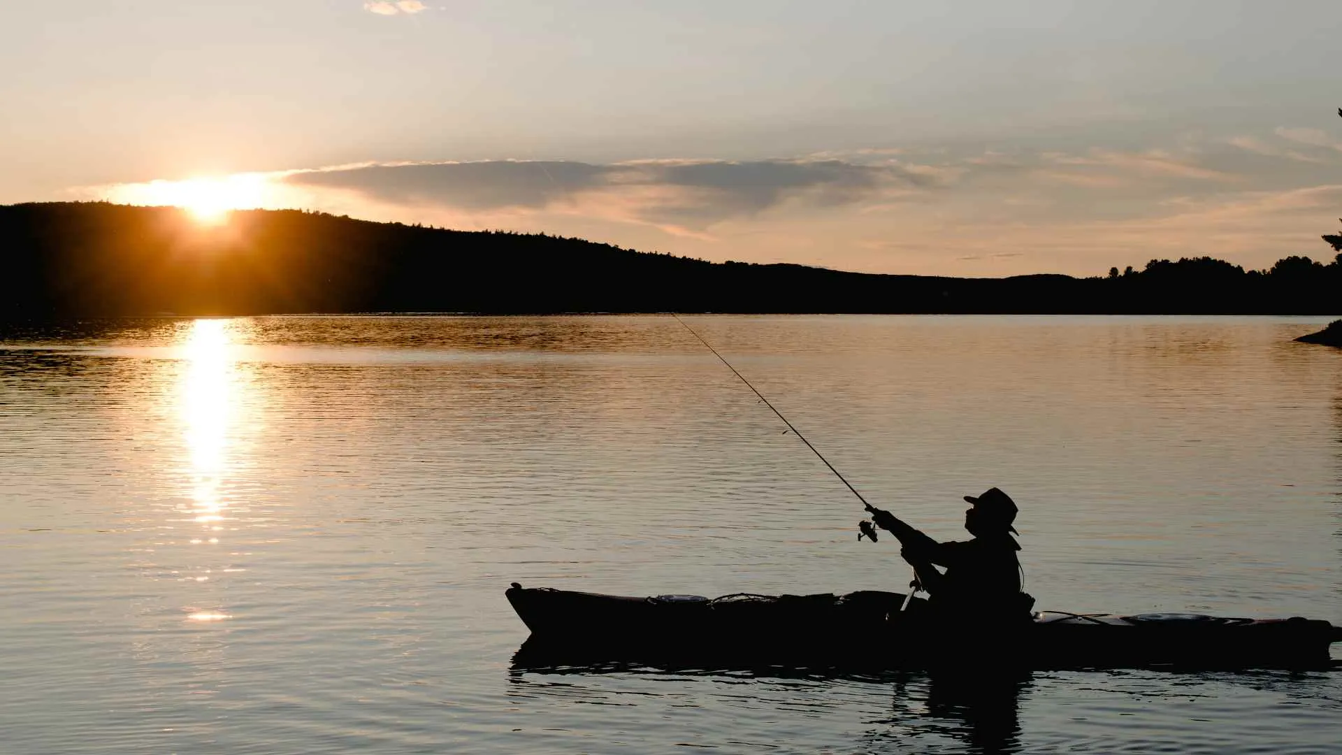 fishing in kayak during sunset