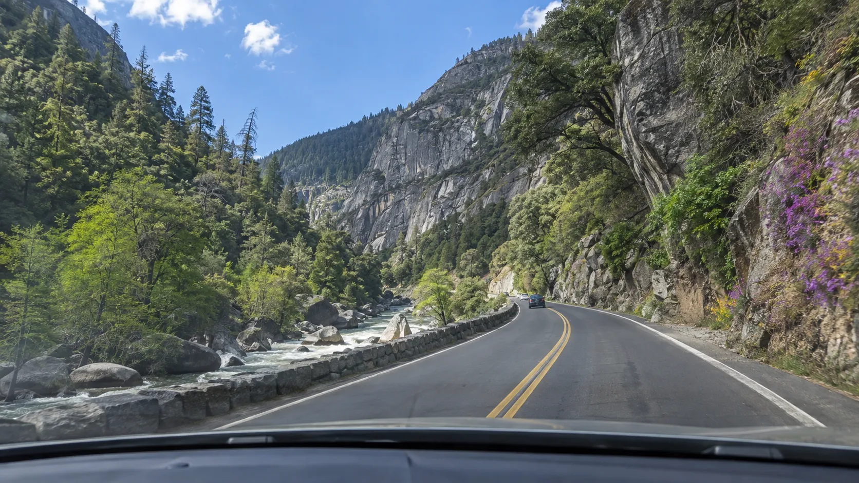 Highway 140 following the Merced River through a granite canyon near El Portal