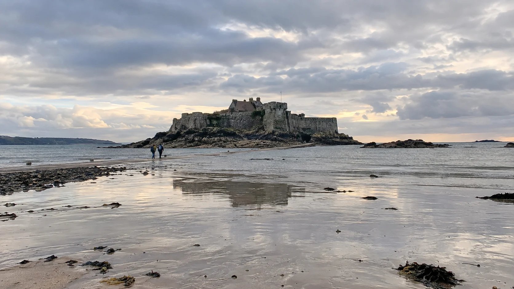 Elizabeth Castle reached by the tidal causeway across wet sand in Jersey
