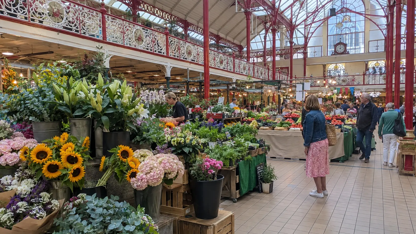 Flowers and produce beneath the ornate ironwork of St. Helier Central Market