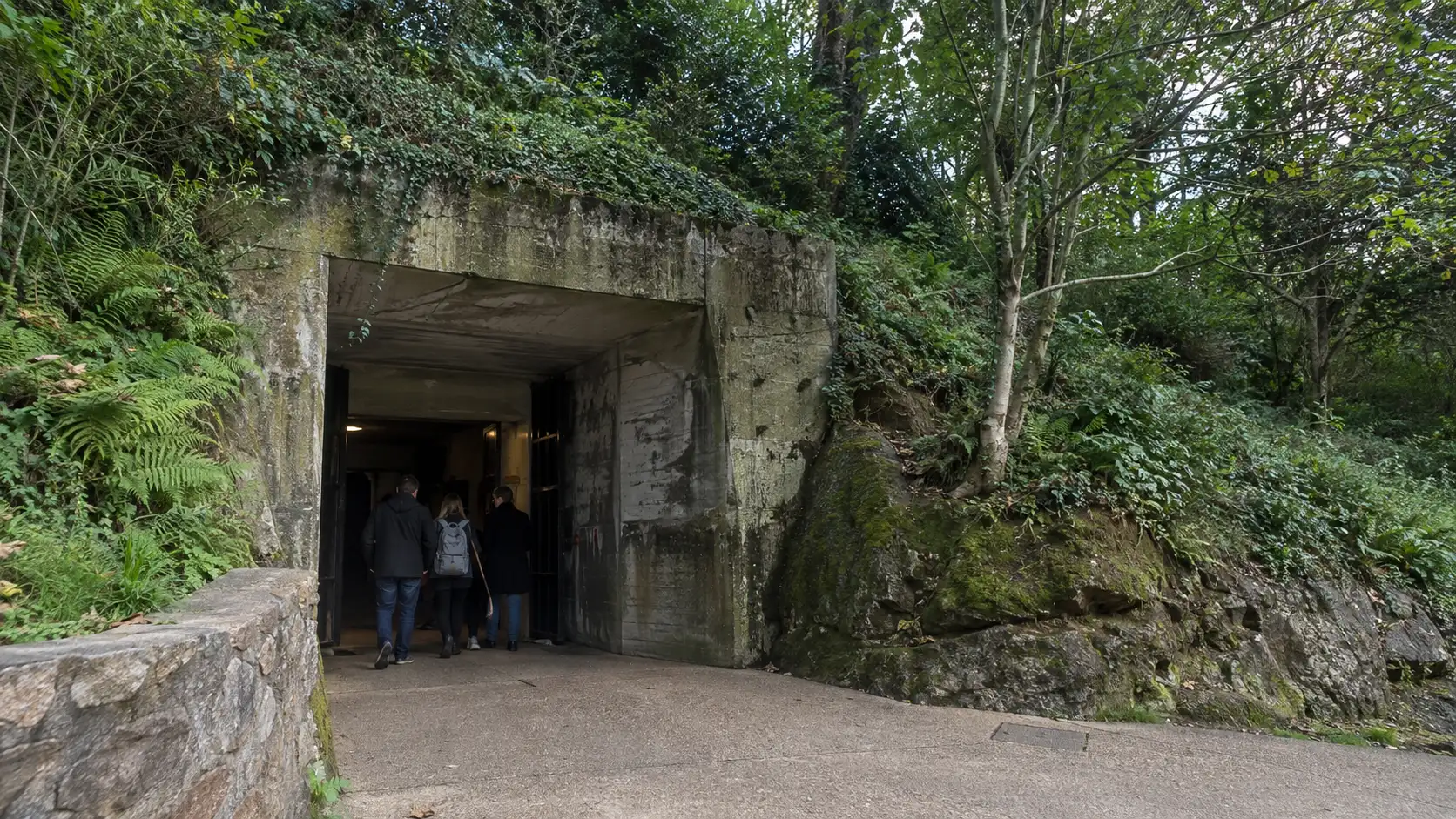 Visitors entering the wooded concrete entrance to the Jersey War Tunnels