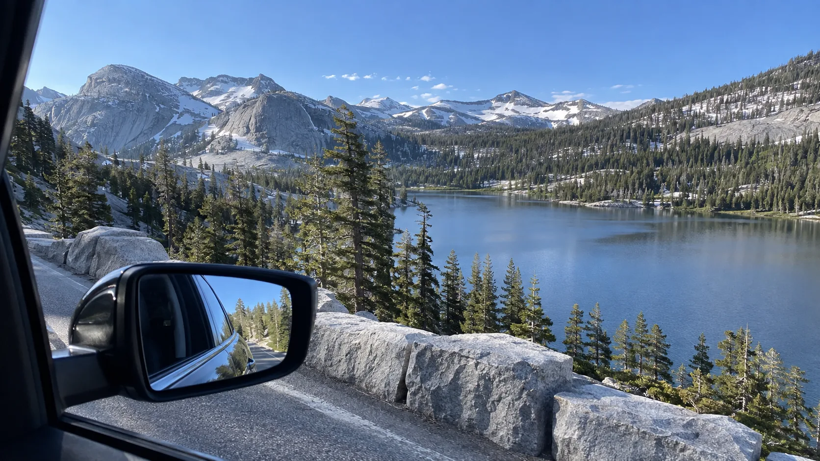 Roadside view of an alpine lake and granite peaks along Tioga Pass