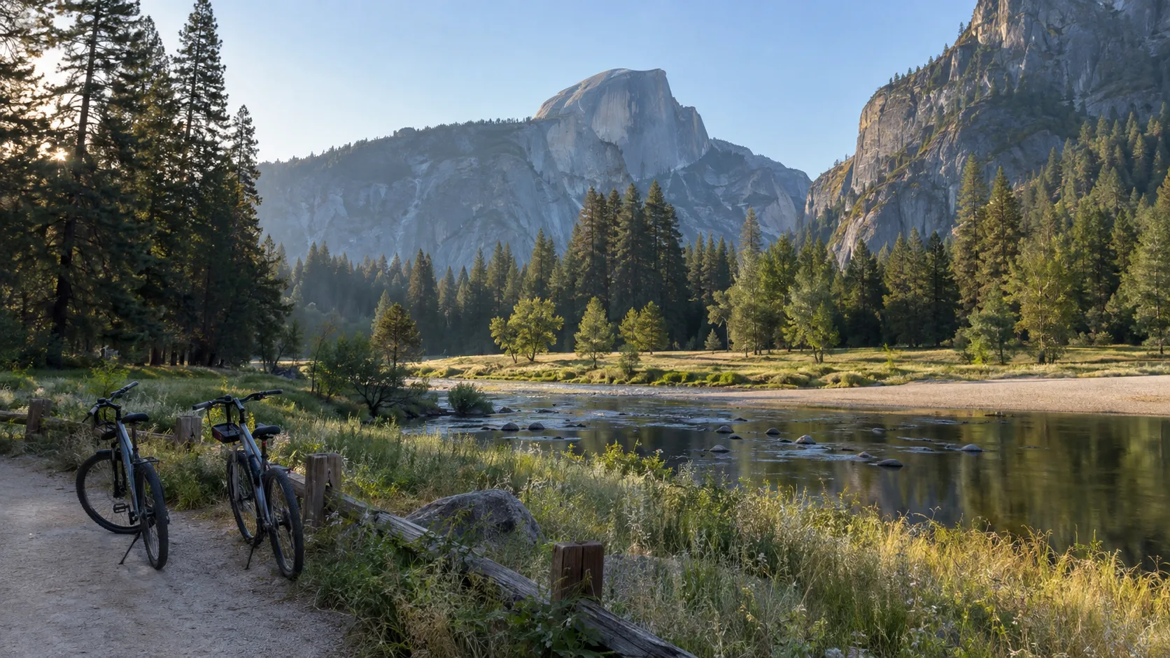 Bicycles beside the Merced River with Half Dome glowing in Yosemite Valley
