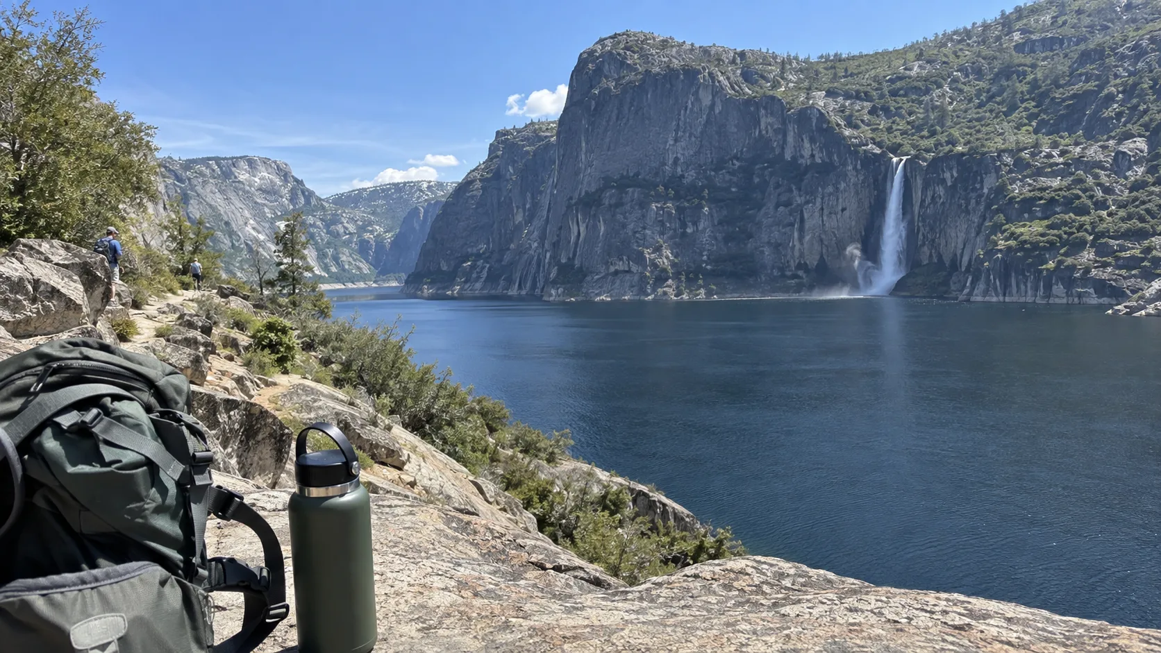 Hiking gear overlooking Hetch Hetchy Reservoir and its waterfall