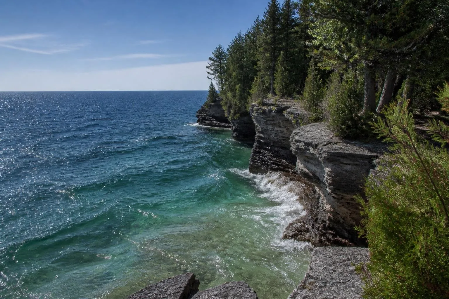 Limestone cliffs and blue Lake Michigan water at Cave Point County Park