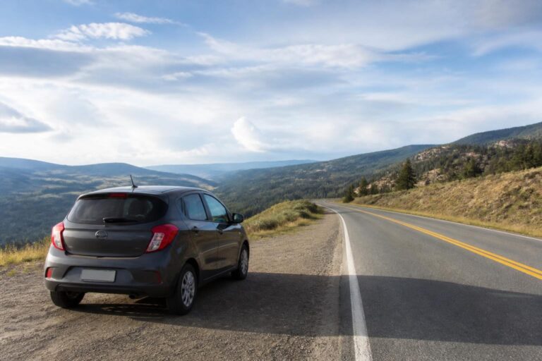 Car parked at a scenic overlook on a quiet road trip