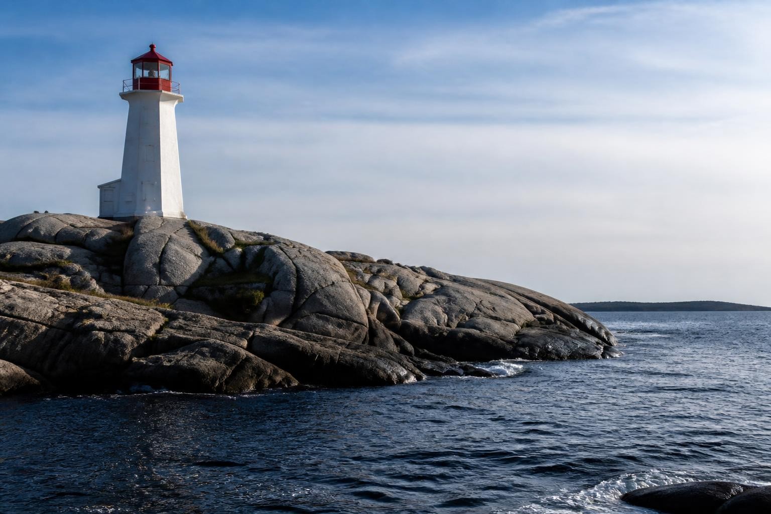 Peggy's Cove lighthouse on granite rocks beside the Atlantic