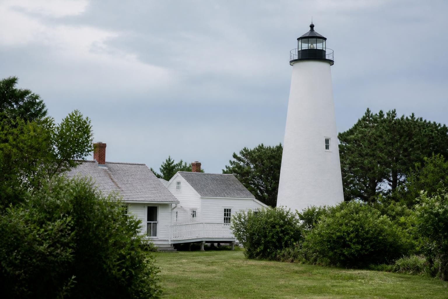 Ocracoke Lighthouse surrounded by coastal greenery