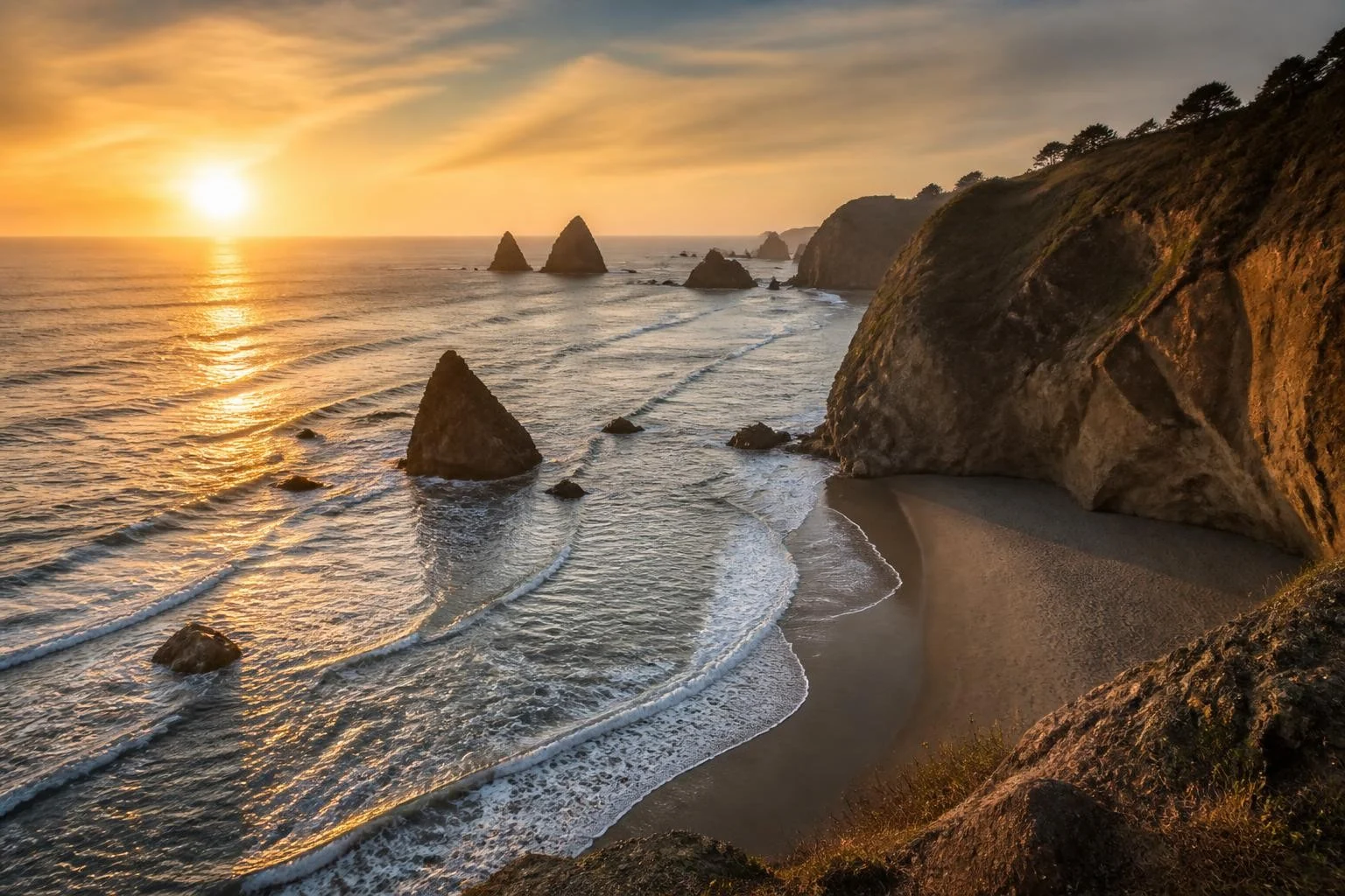 Sea stacks and rugged Oregon Coast cliffs at sunset