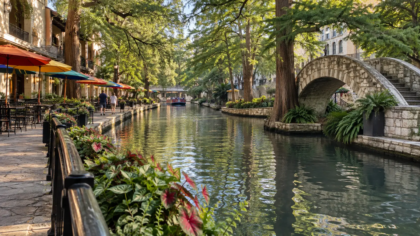 The San Antonio River Walk curves beneath cypress trees and an arched bridge.