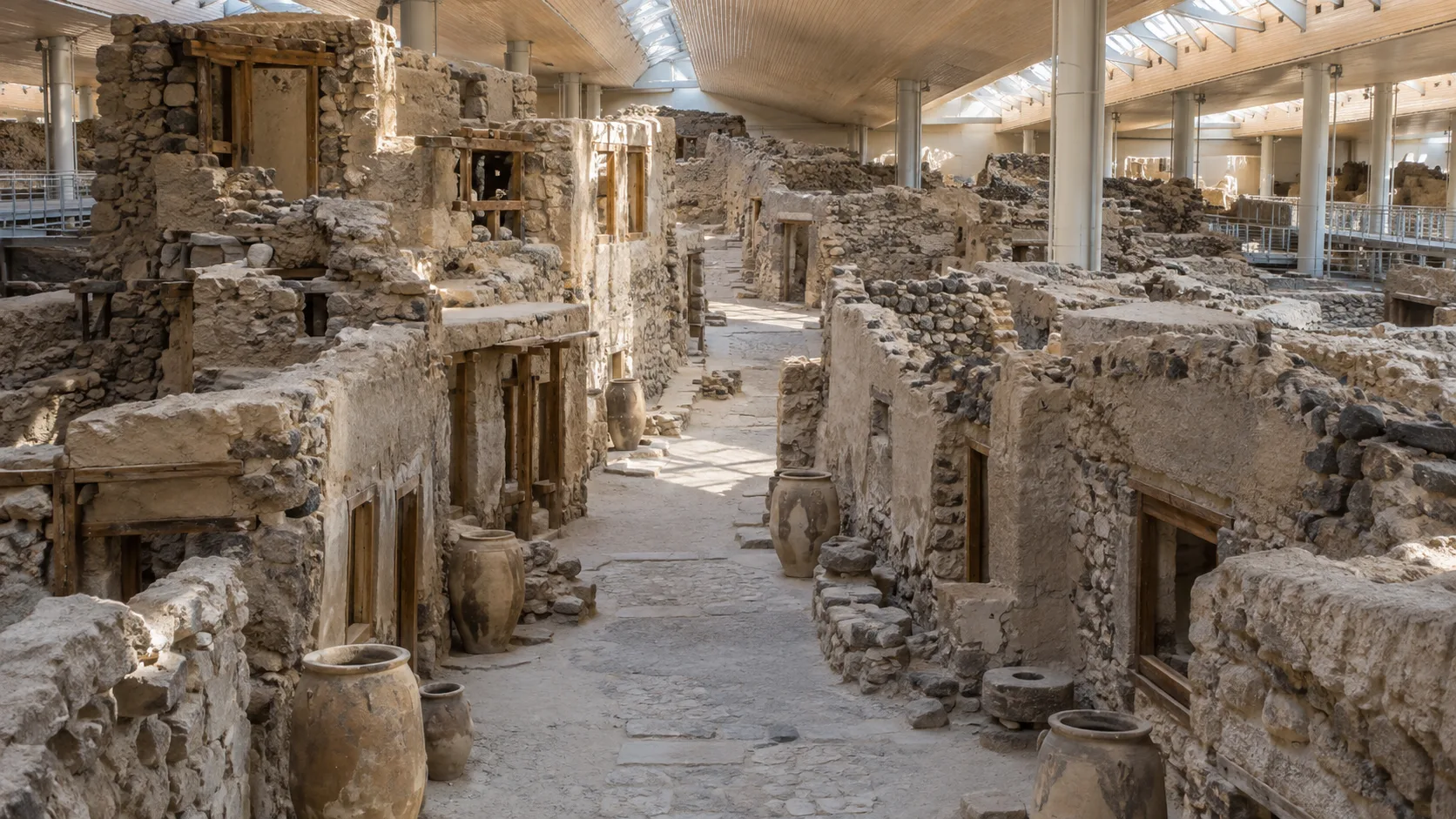 Preserved Bronze Age buildings and pottery beneath the protective roof at Akrotiri on Santorini