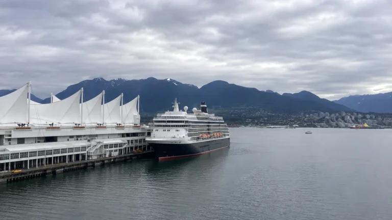 Cruise ship docked beside the white sails of Canada Place in Vancouver