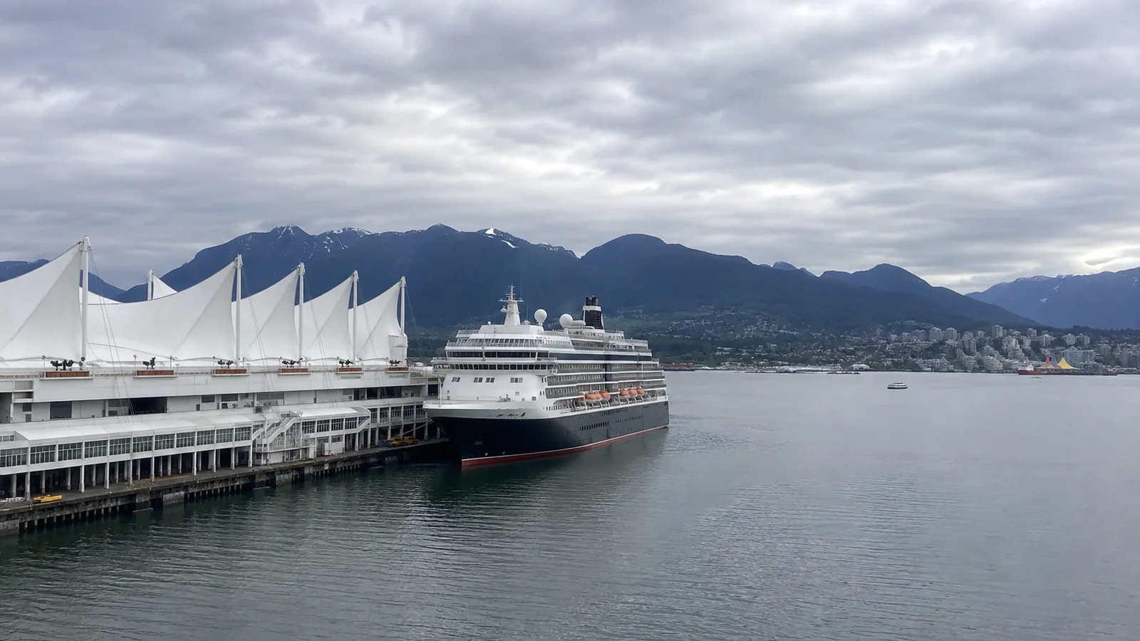 Cruise ship docked beside the white sails of Canada Place in Vancouver