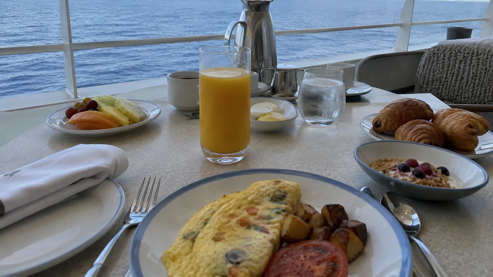 Breakfast spread on a dining table beside a large window
