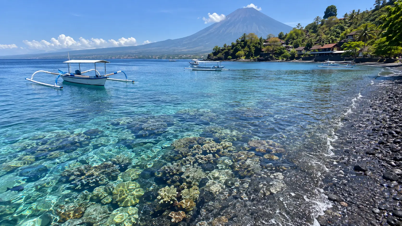 Clear water and traditional outrigger boats at Jemeluk Bay in Amed.