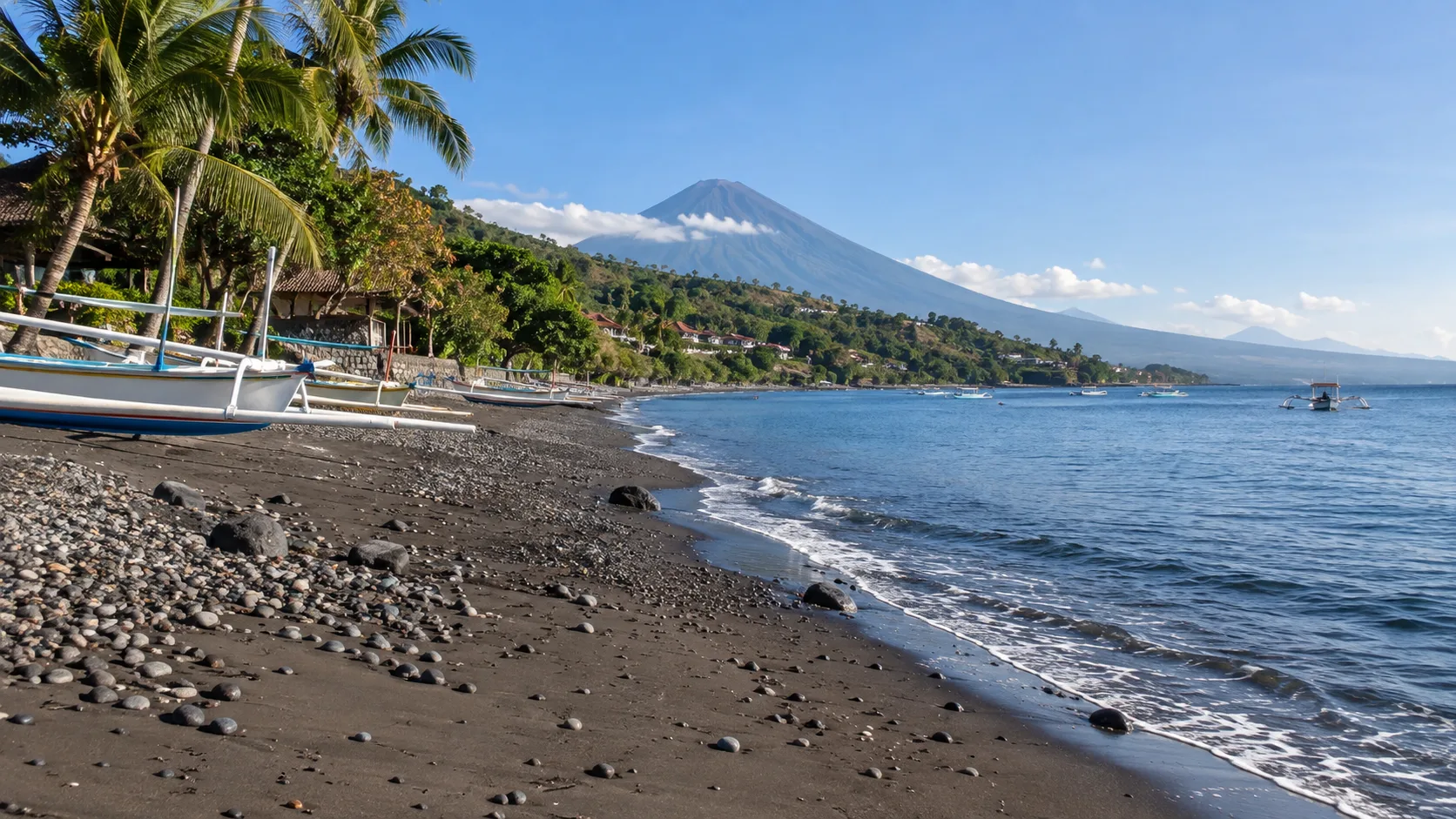 Quiet Lipah Beach with calm water and outrigger boats in Amed.