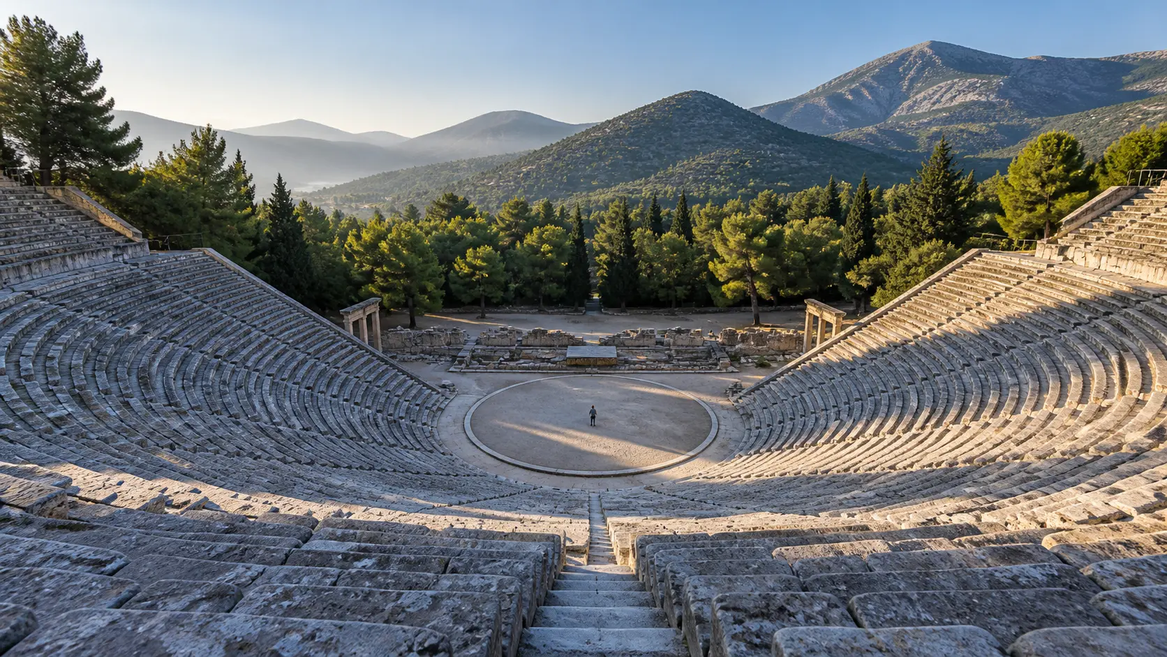 Concentric limestone seats surrounding the orchestra of the Ancient Theater of Epidaurus