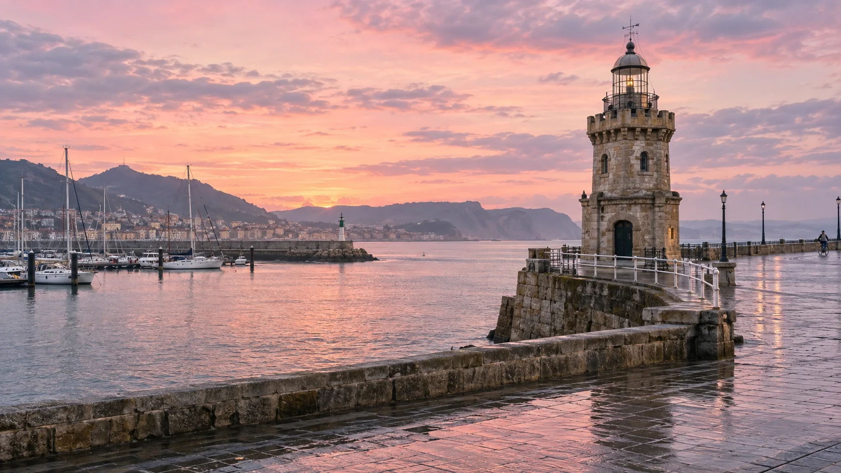 Historic stone Arriluze Lighthouse beside the harbor at a pastel dawn in Getxo, Spain.