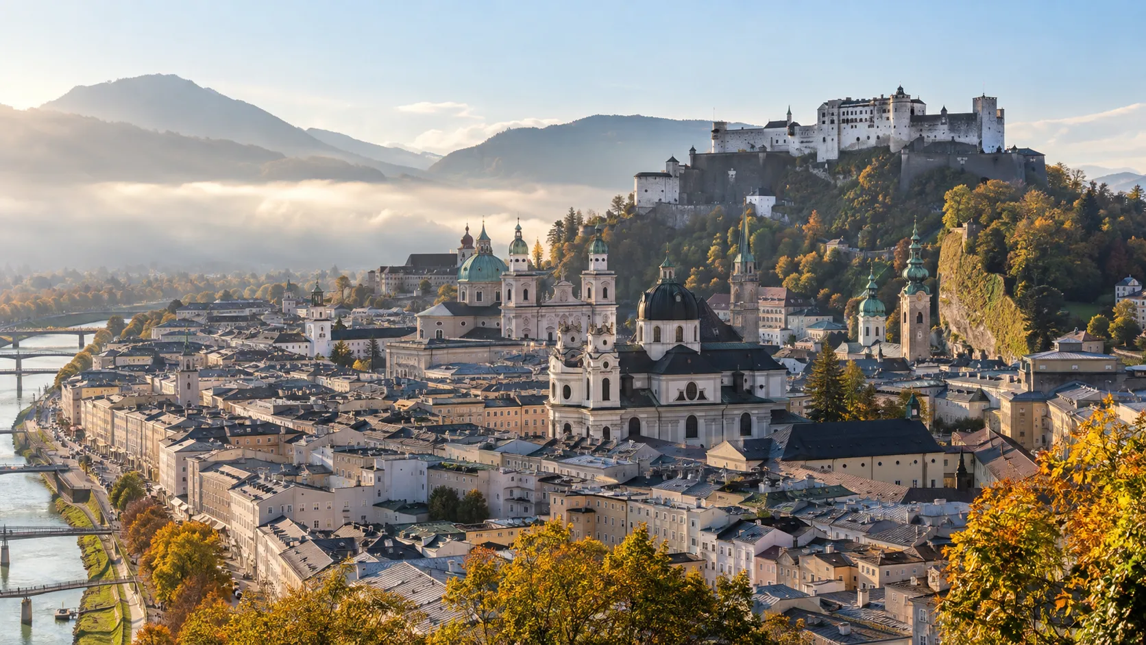 Hohensalzburg Fortress rising above Salzburg's church domes on an autumn morning.