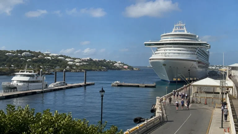 Cruise ship docked at a Bermuda terminal viewed from an elevated walkway