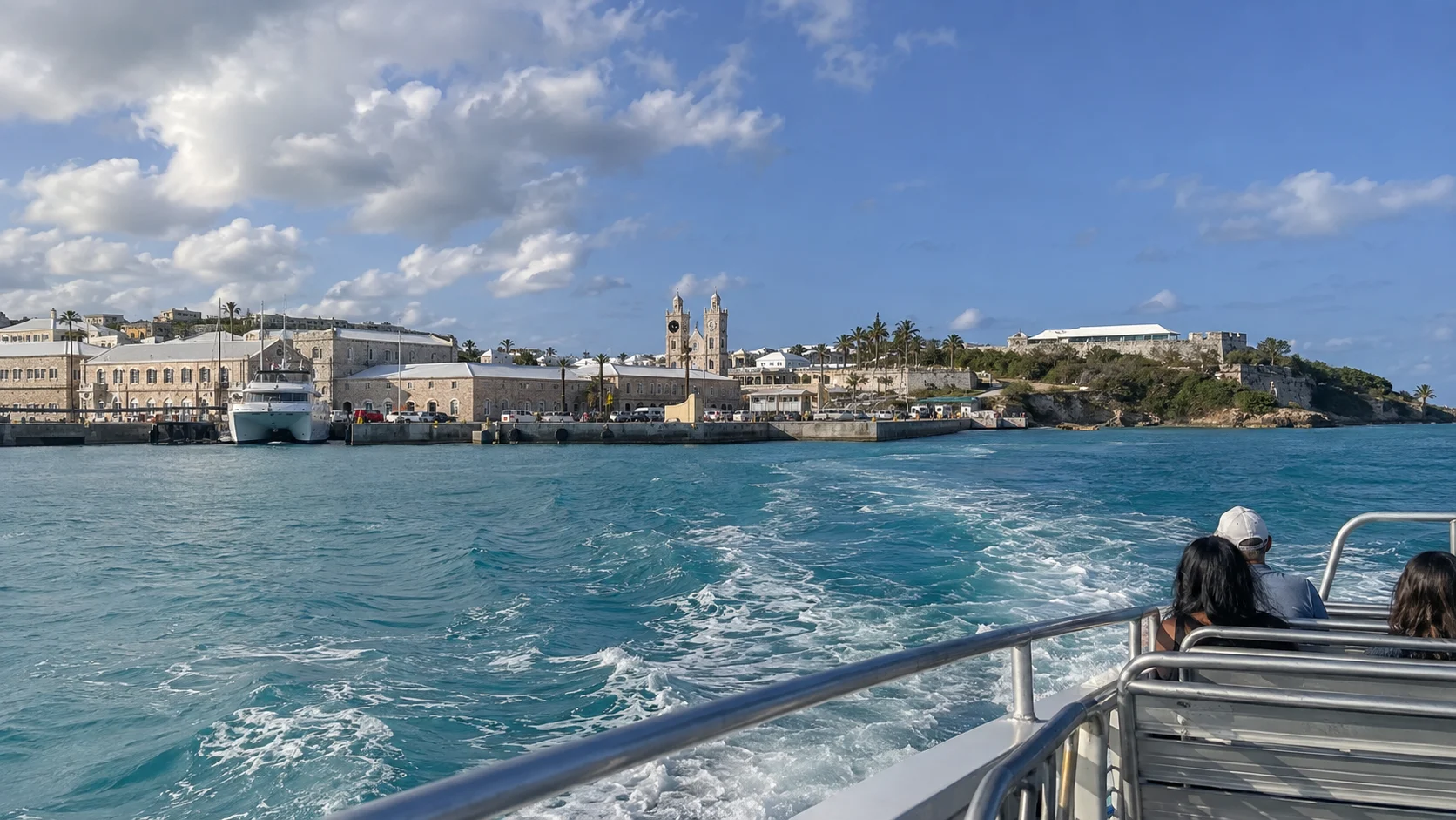 Public ferry departing Royal Naval Dockyard across blue water.