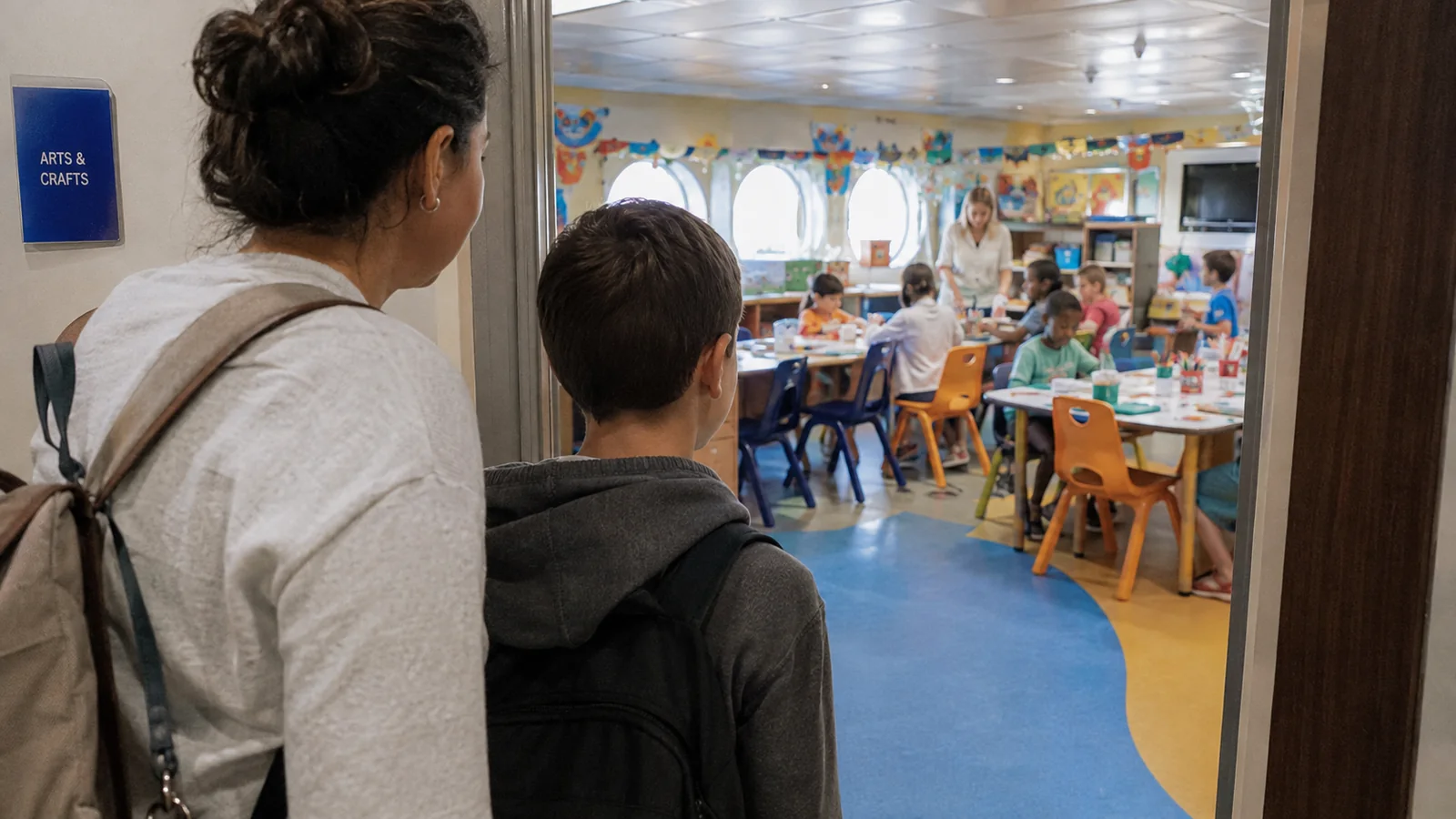 Parent and child looking into a colorful children's activity room.
