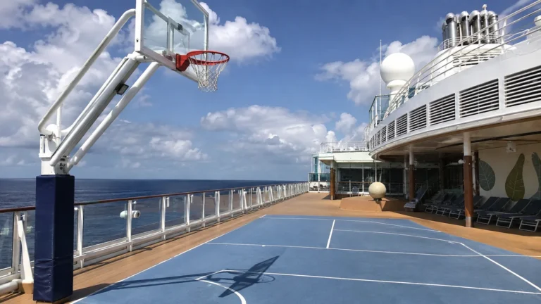Empty blue basketball court on a cruise ship's open deck.