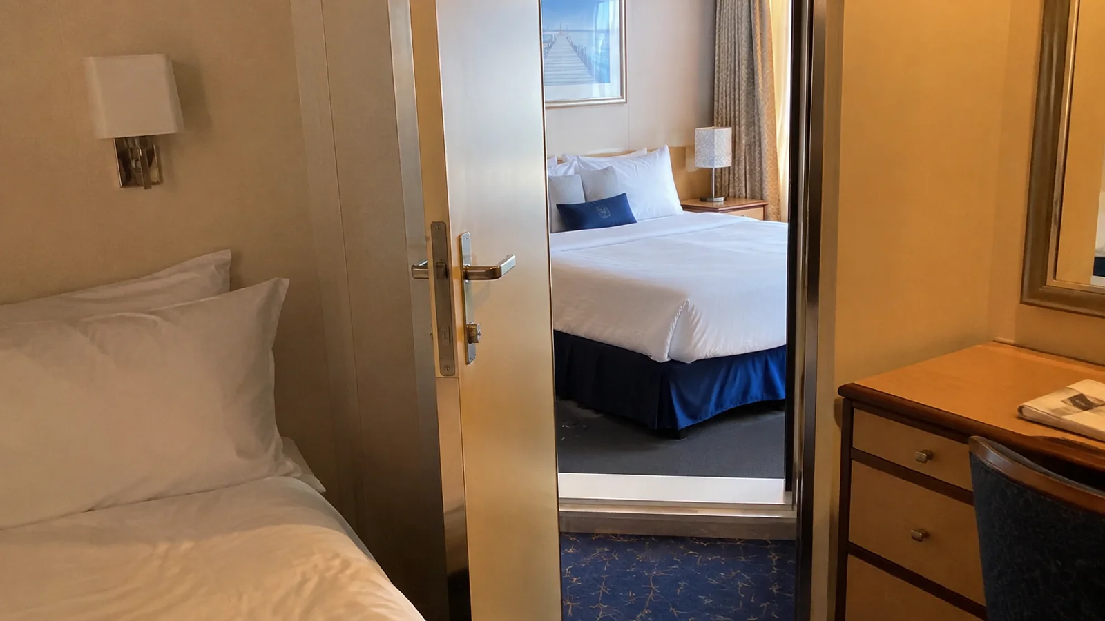 Open connecting door between two cruise cabins.