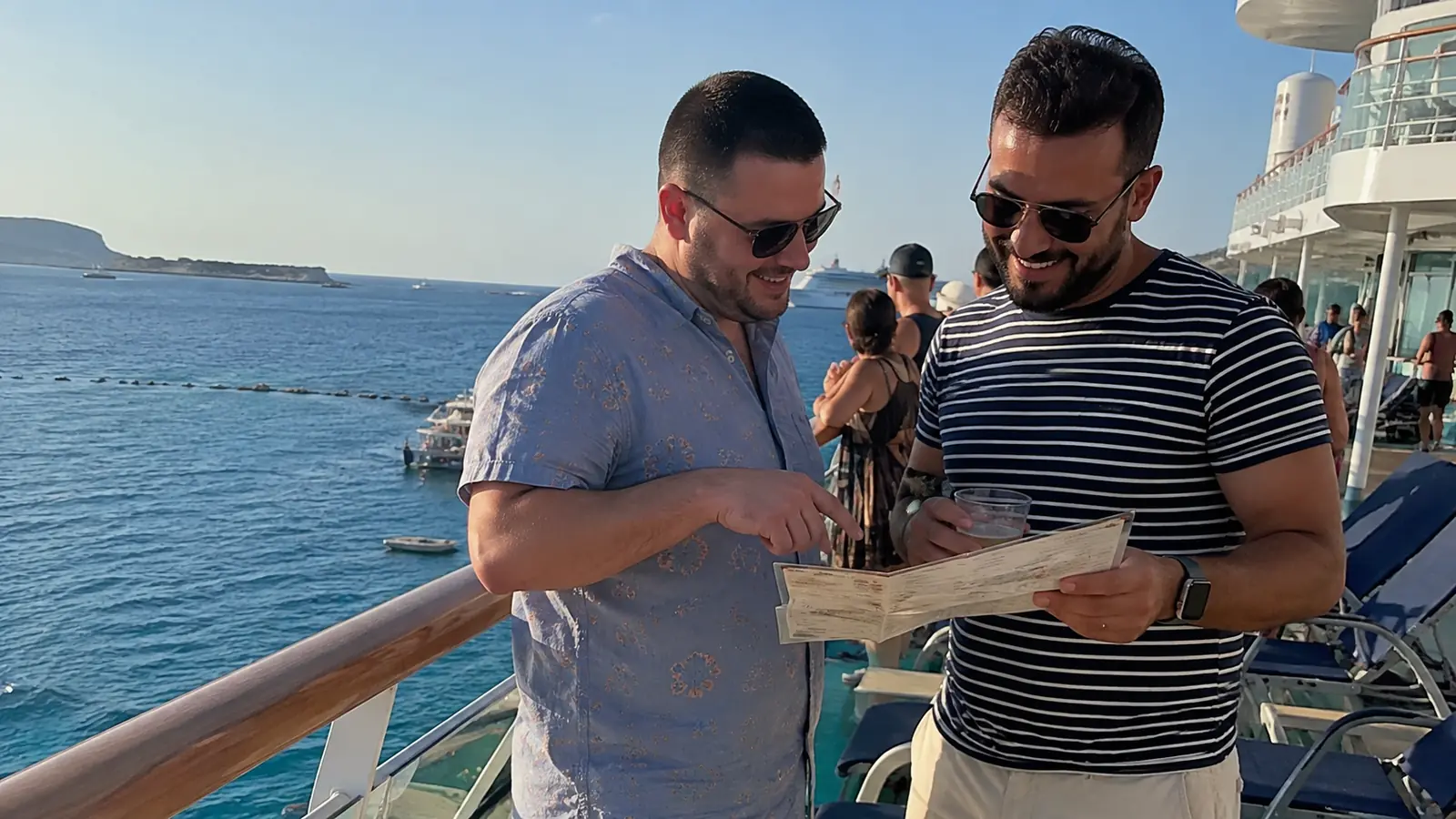 Passengers enjoying a relaxed day on a Pride-themed cruise