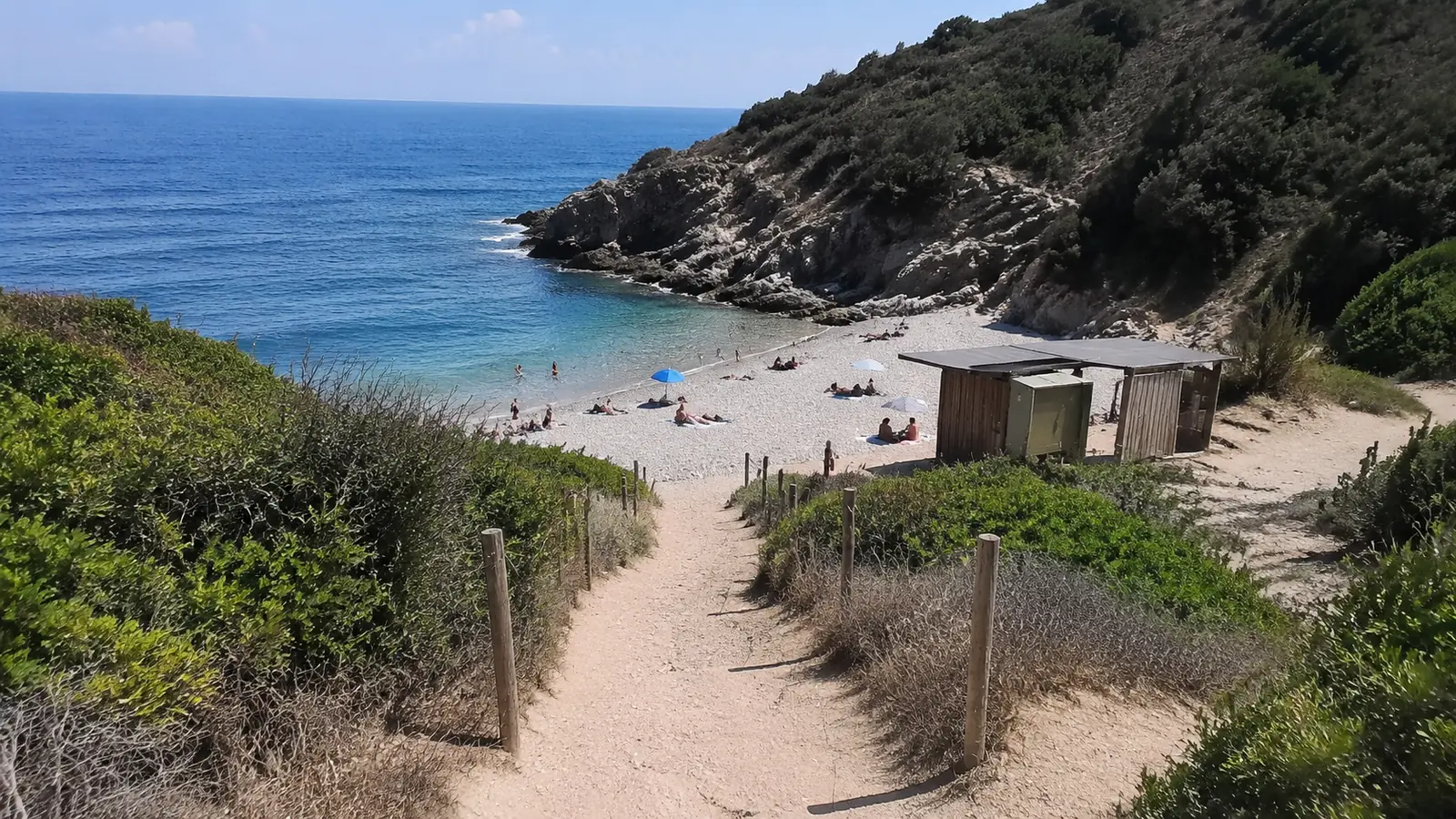 Wide coastal view of a clothing-optional beach destination