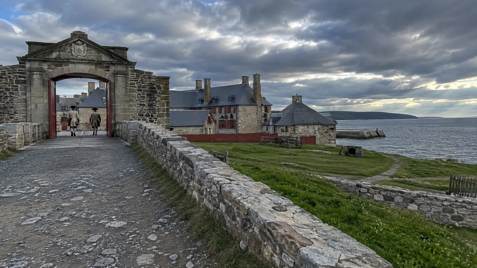 Historic stone gate and waterfront buildings at Fortress of Louisbourg