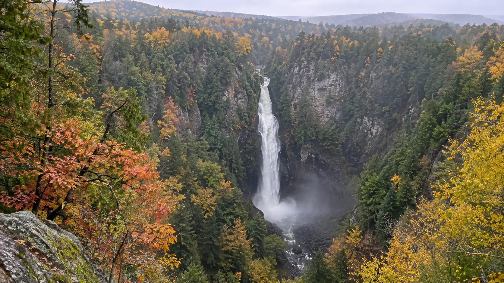 Big Manitou Falls drops into a deep autumn gorge at Pattison State Park.