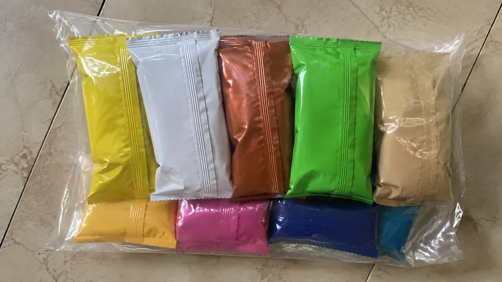 Colorful individually wrapped snack bars are arranged in a clear bag.