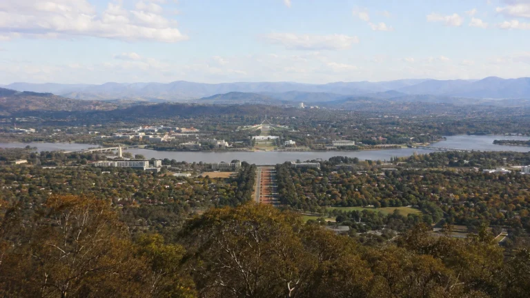Elevated view of a city arranged around a broad lake.