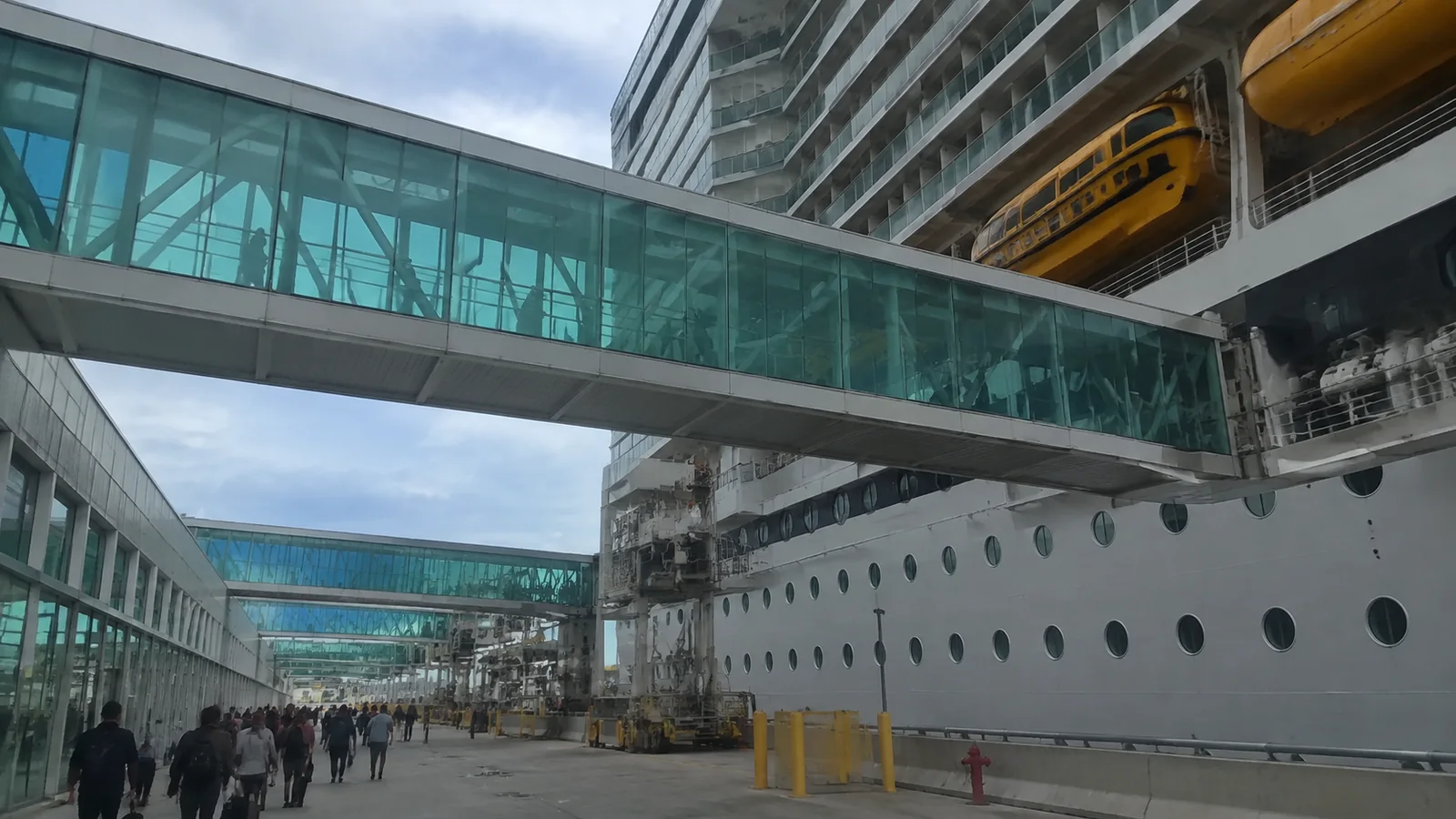 Enclosed gangway beside a docked cruise ship