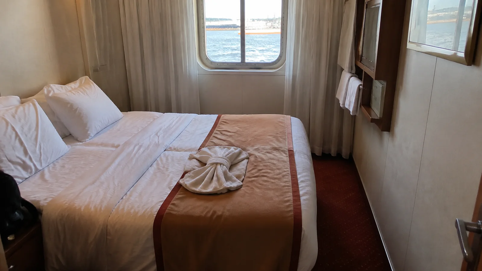 Cruise cabin with a double bed and ocean-view window