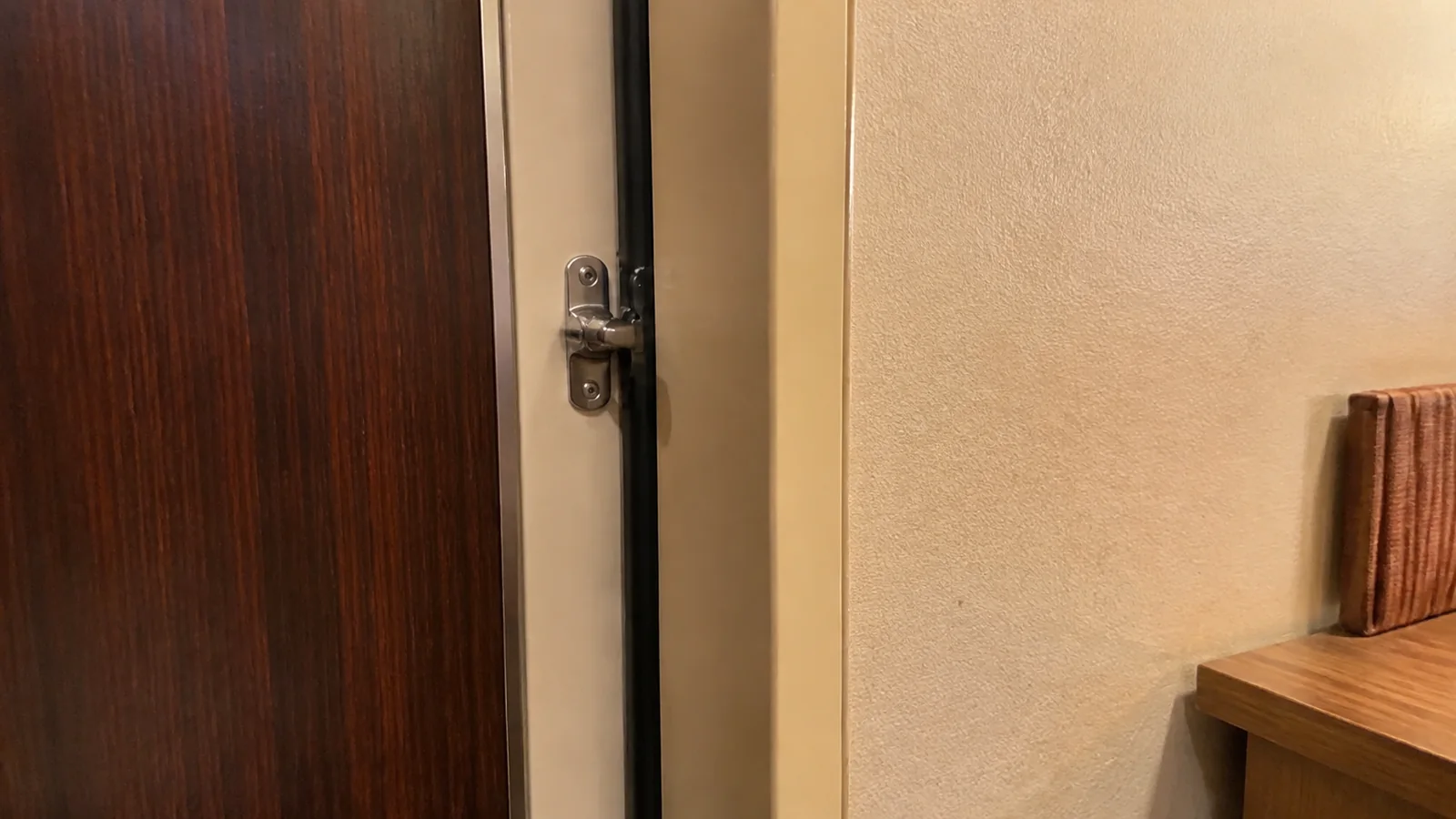 Connecting door beside a desk inside a cruise cabin
