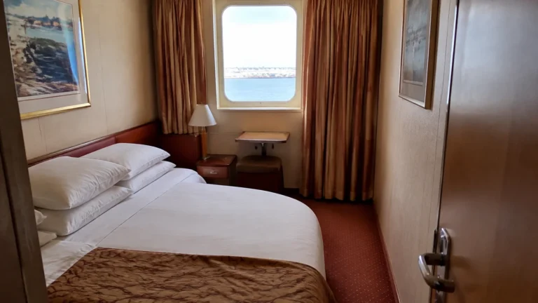 Compact cruise cabin with a double bed and window