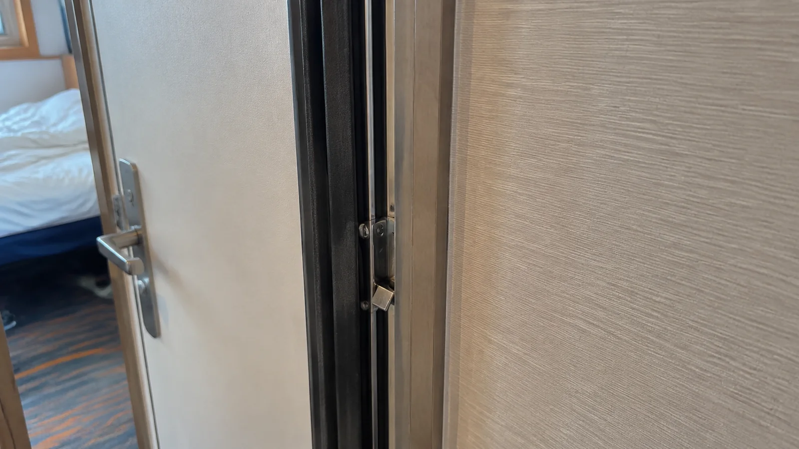 Partially open connecting door between cruise cabins