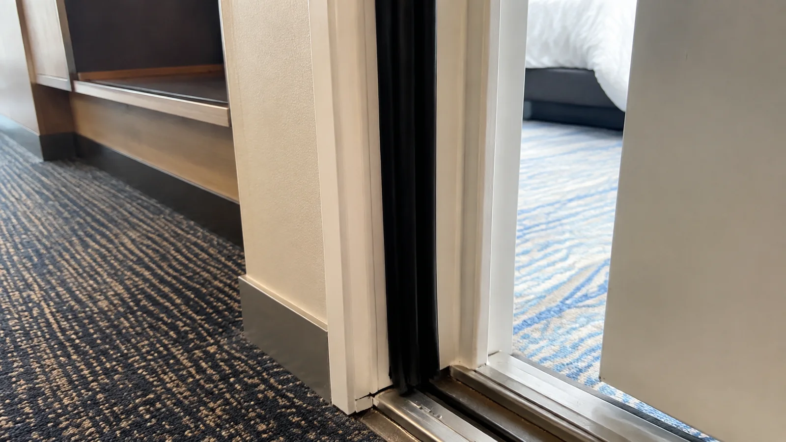Close view of the threshold and doorway between connecting cabins.