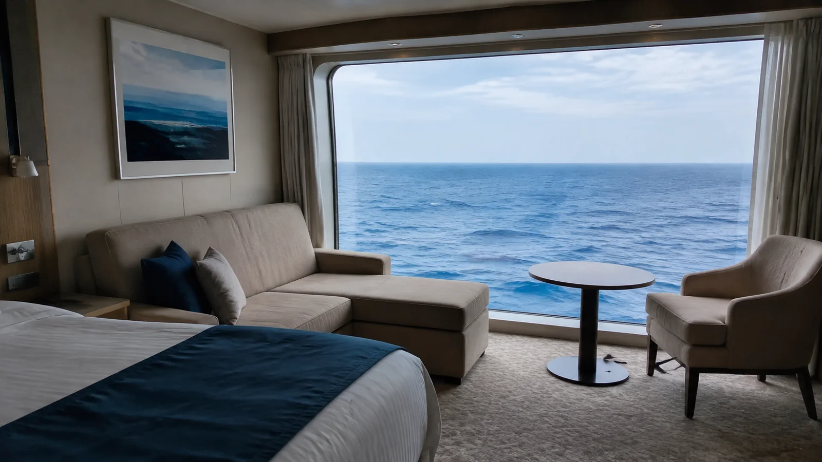 Cabin sitting area with large windows overlooking the ocean.