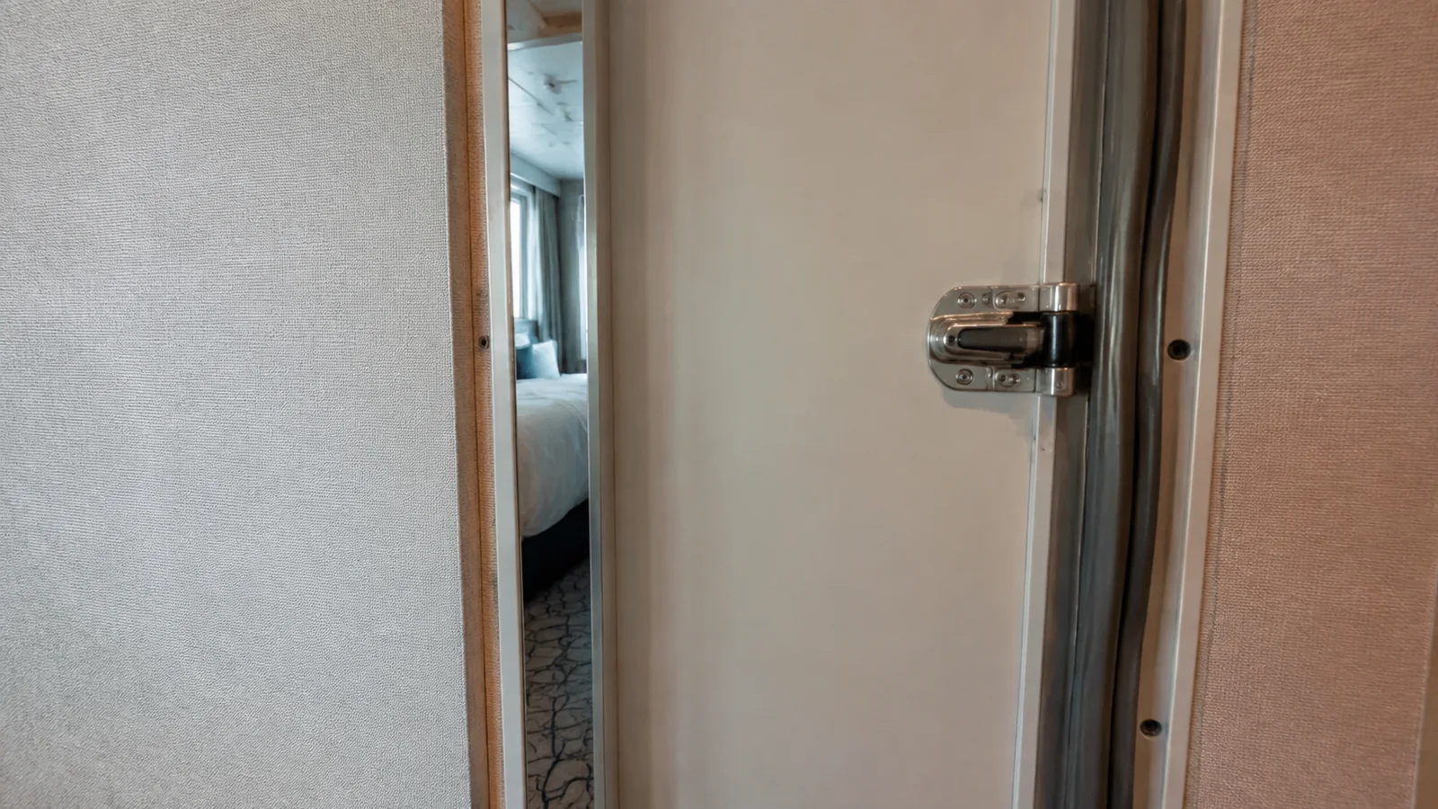 Close-up of a security latch on a partially open connecting cabin door
