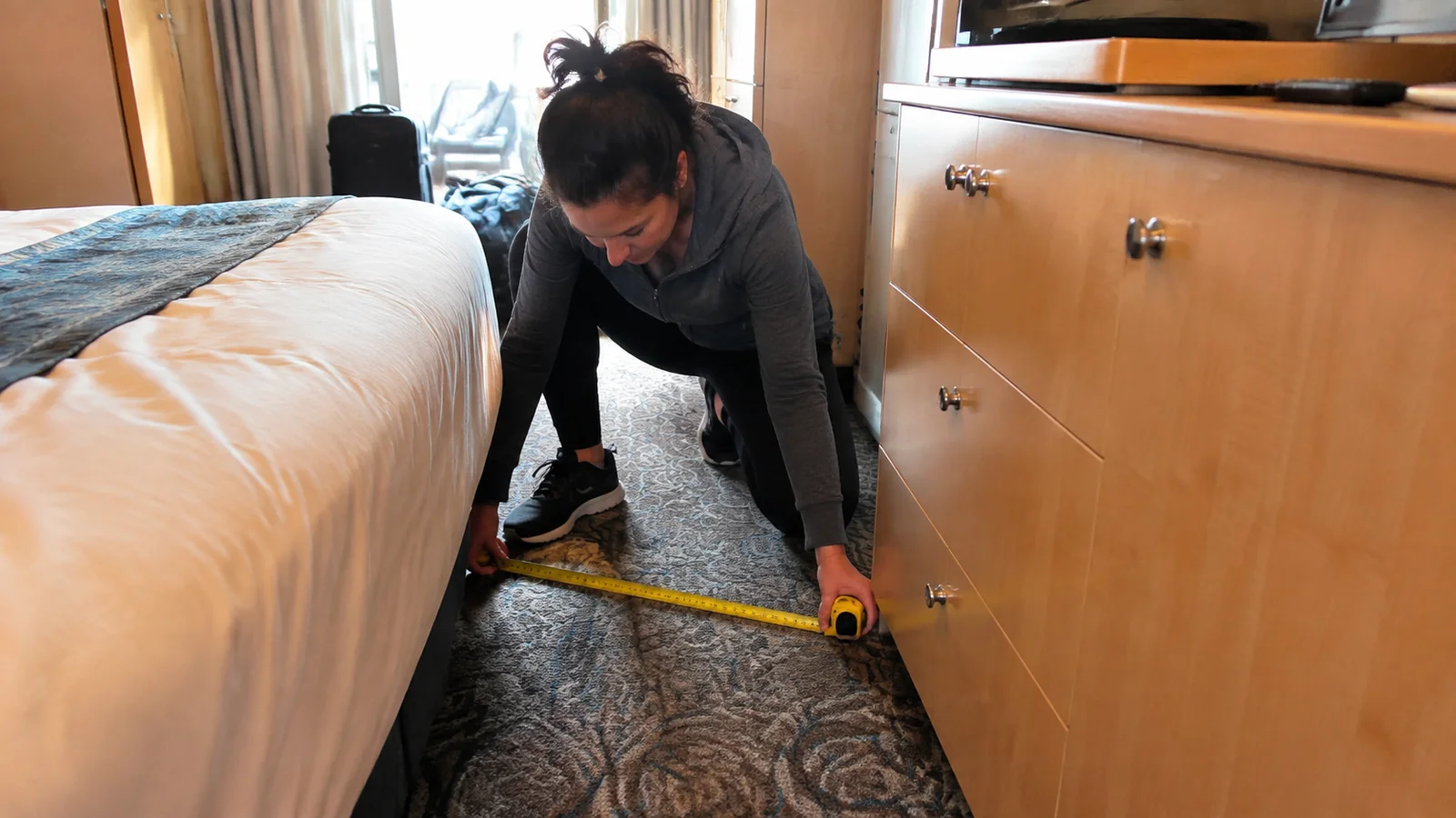 Passenger measuring the floor space beside a cabin bed.