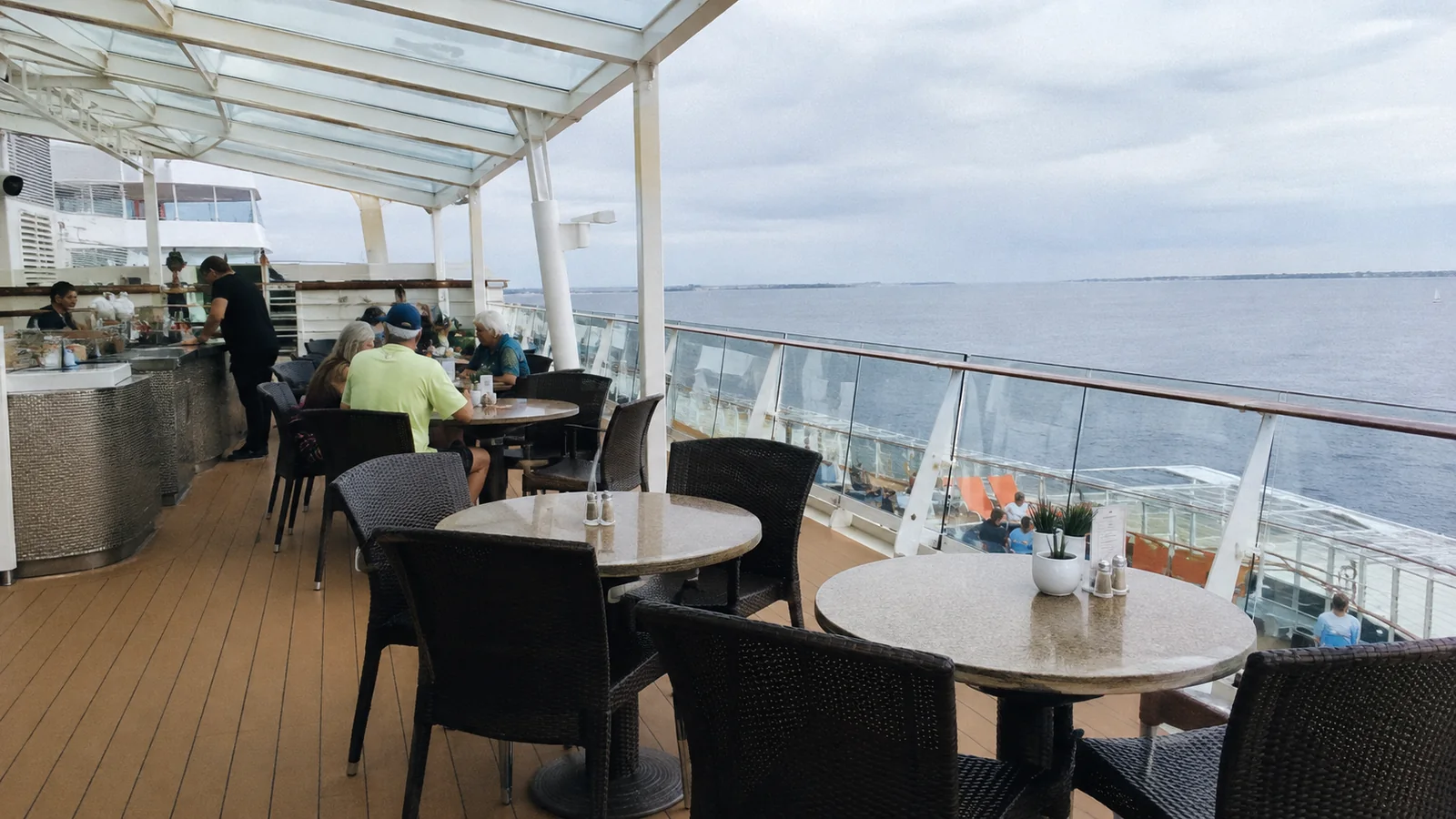 Covered outdoor dining terrace overlooking the sea.