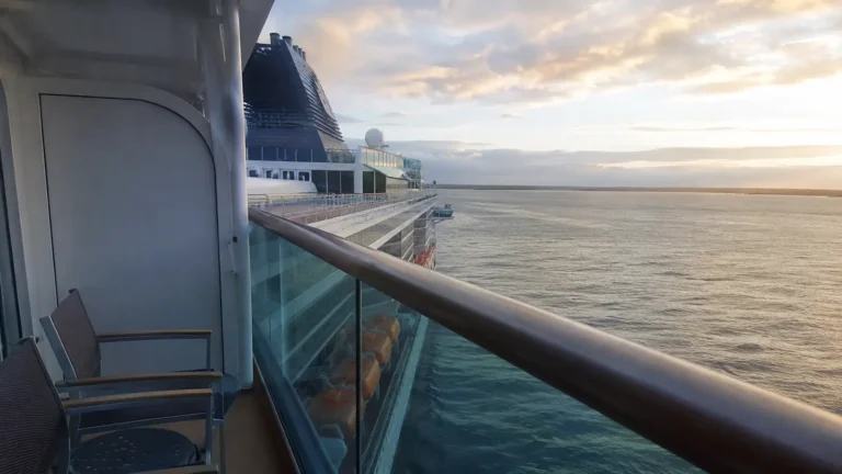 Cruise ship balcony overlooking another ship docked alongside