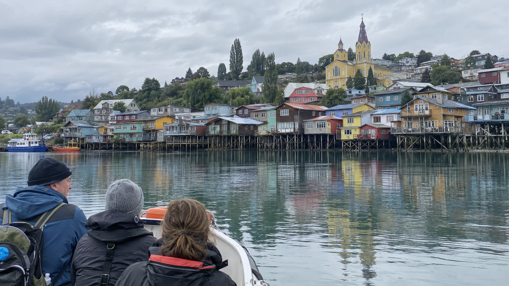 Cruise tender approaching Castro's colorful waterfront palafitos