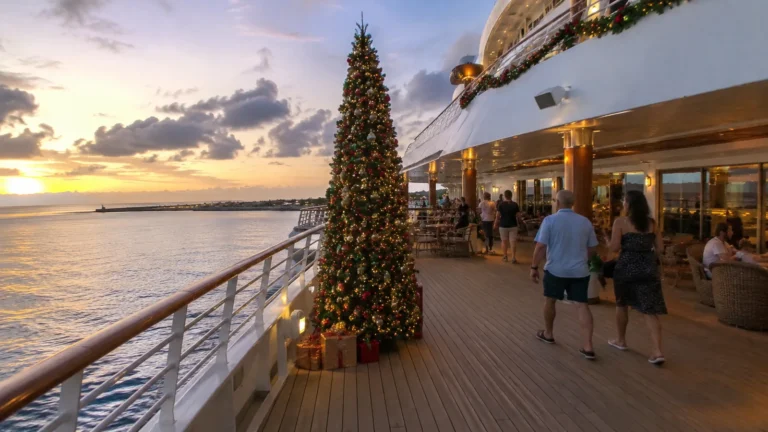 Decorated Christmas tree on an outdoor cruise ship deck at sunset