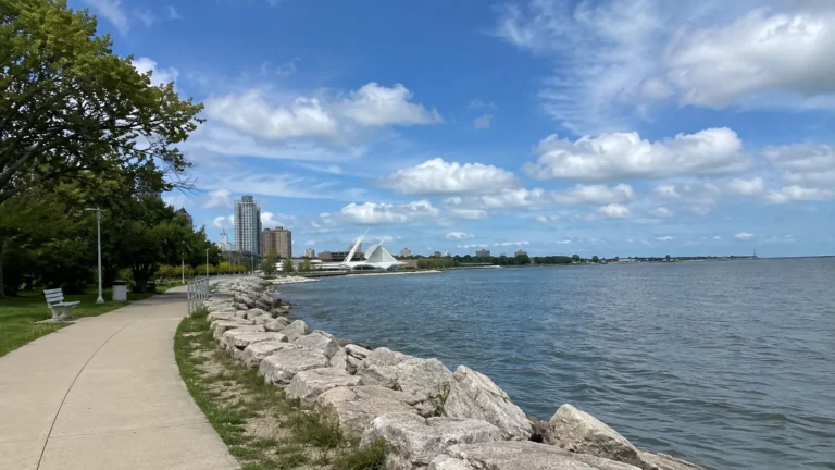 Lakeside walking path with Milwaukee's waterfront buildings in the distance.